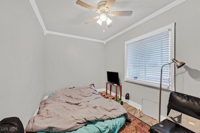 bedroom with baseboards, ceiling fan, and crown molding