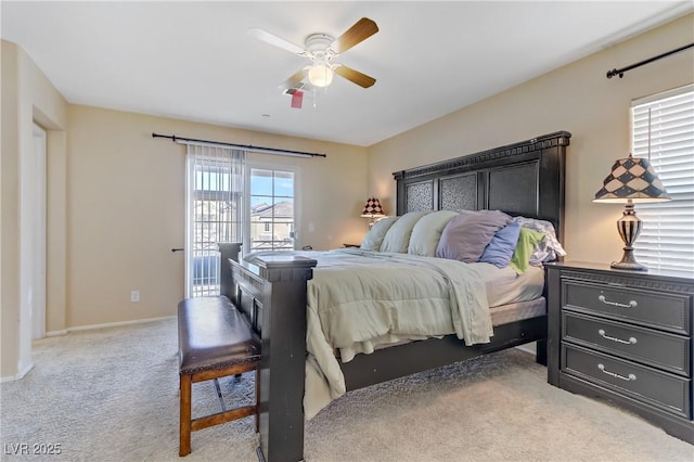 carpeted bedroom featuring access to outside, a ceiling fan, and baseboards