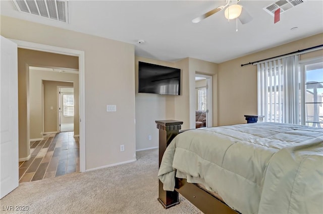 carpeted bedroom with multiple windows, visible vents, and baseboards