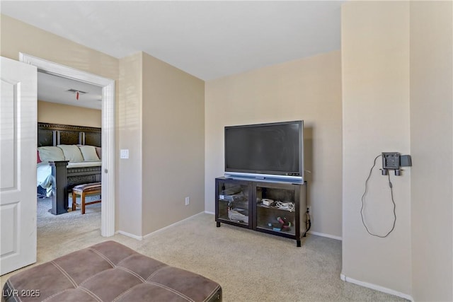 carpeted living area with baseboards