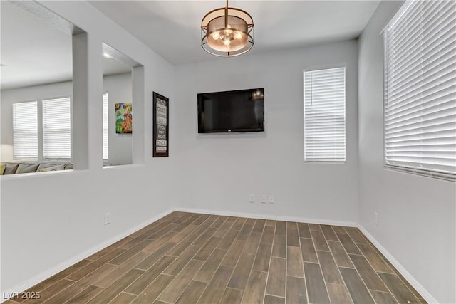 empty room featuring wood finish floors and baseboards