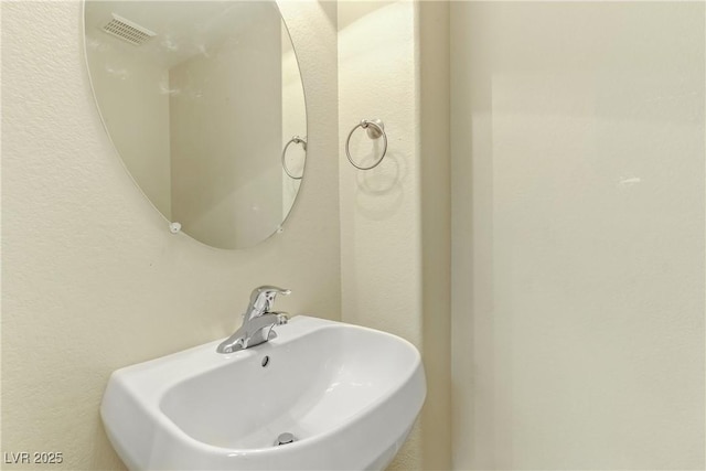 bathroom with visible vents and a sink