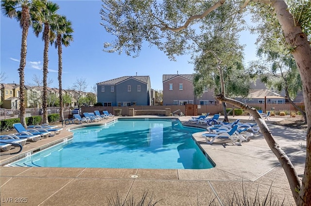 pool featuring a patio area, a residential view, and fence