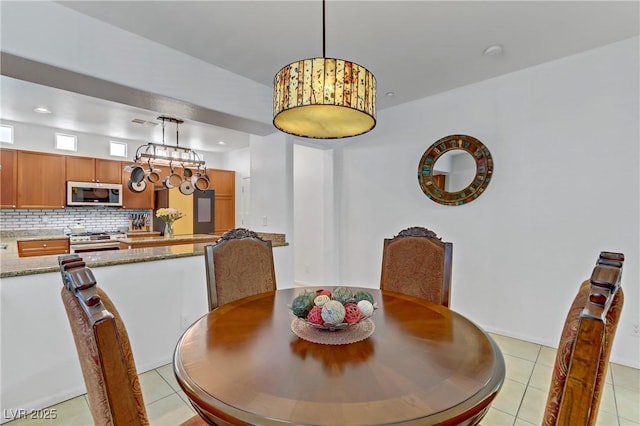 dining area featuring light tile patterned floors and recessed lighting