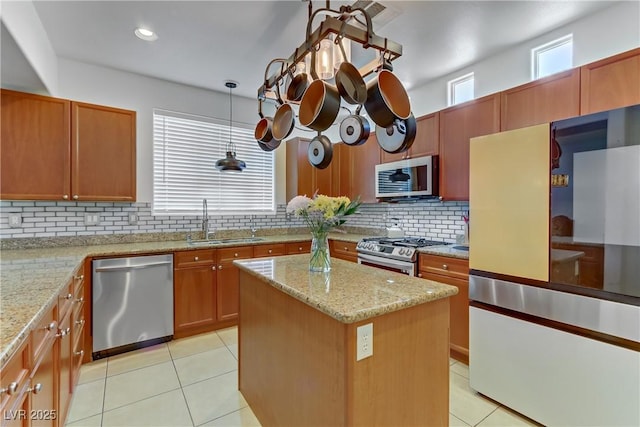 kitchen featuring light tile patterned floors, a center island, a sink, stainless steel appliances, and backsplash