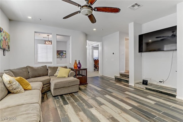 living area featuring a wealth of natural light, wood finished floors, visible vents, and recessed lighting