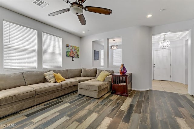 living area with a ceiling fan, visible vents, wood finished floors, and recessed lighting