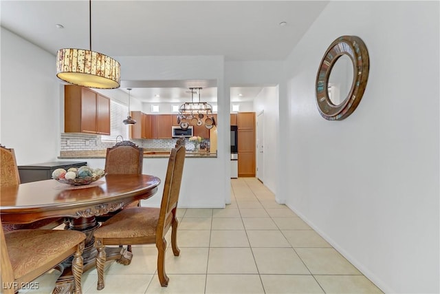 dining space featuring light tile patterned flooring