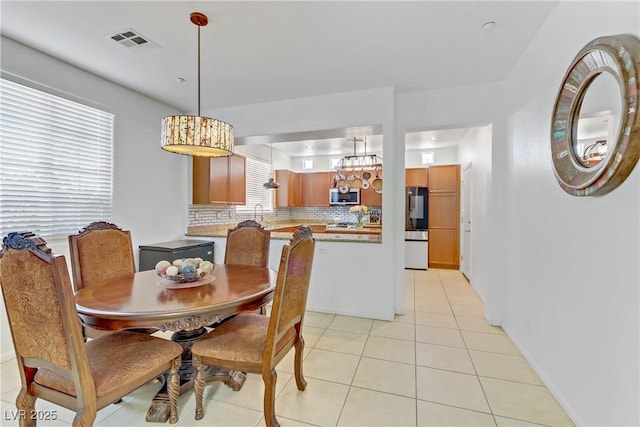 dining room with light tile patterned flooring and visible vents