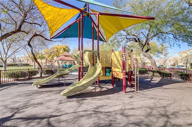 community jungle gym featuring fence