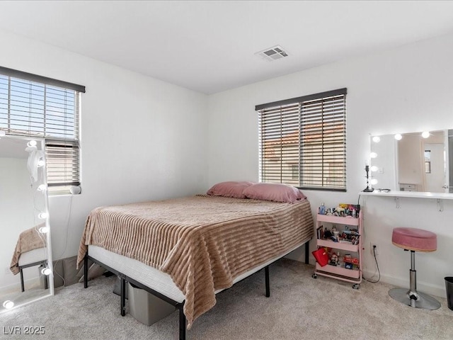 bedroom featuring light carpet and visible vents