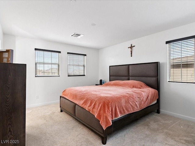 bedroom with carpet, visible vents, and baseboards