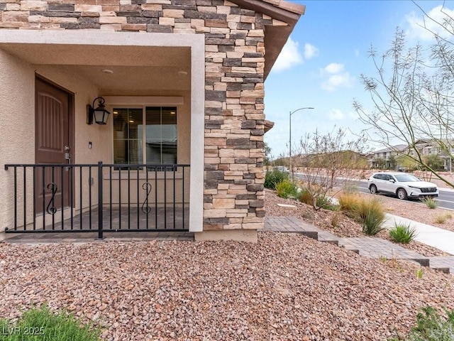 entrance to property featuring stucco siding