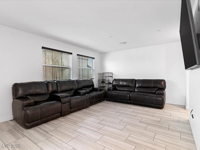 living room featuring baseboards, visible vents, and wood tiled floor