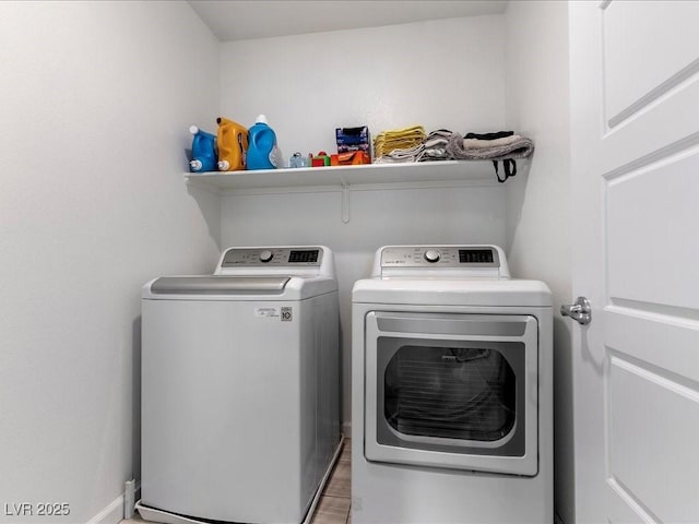 laundry room with laundry area, washer and clothes dryer, wood finished floors, and baseboards