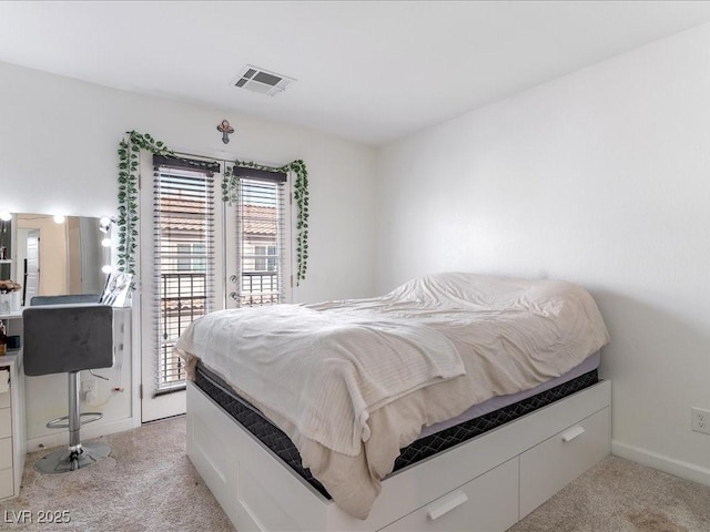 bedroom featuring access to exterior, light colored carpet, visible vents, and baseboards