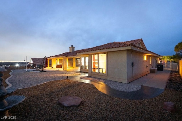 back of property featuring a fenced backyard, a patio, and stucco siding