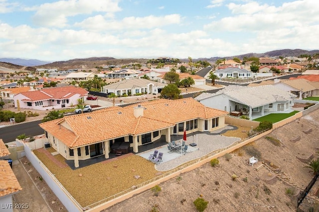 drone / aerial view featuring a residential view and a mountain view