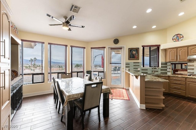 dining area featuring baseboards, visible vents, dark wood finished floors, a ceiling fan, and recessed lighting