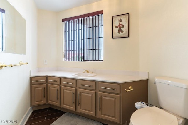 bathroom featuring toilet, wood finish floors, and vanity