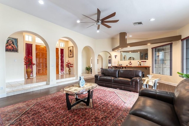 living area with ceiling fan, visible vents, and recessed lighting