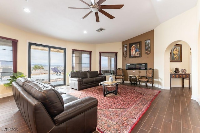 living room with lofted ceiling, baseboards, visible vents, and dark wood-type flooring