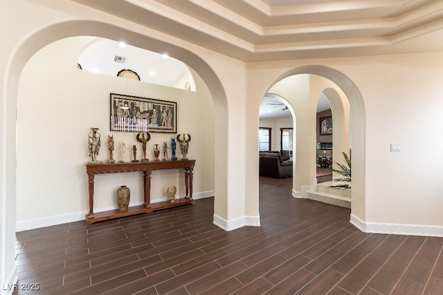 corridor featuring dark wood-style floors, baseboards, and visible vents