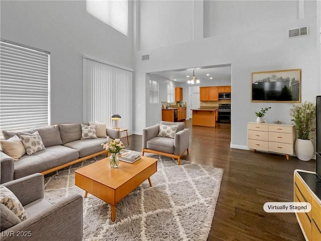 living room with baseboards, visible vents, and dark wood-style flooring