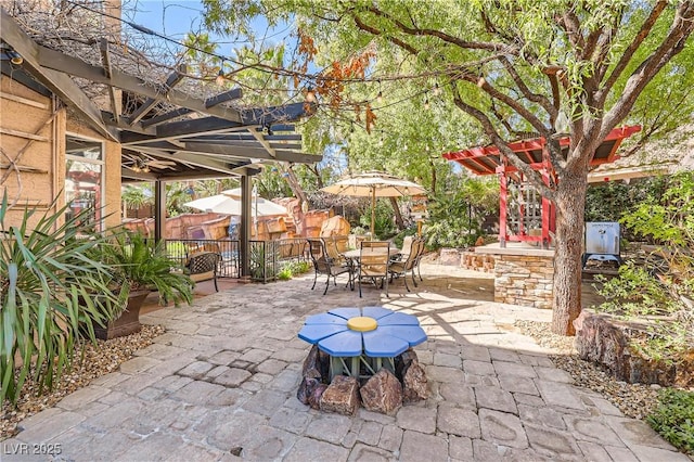 view of patio / terrace with a pergola and outdoor dining space