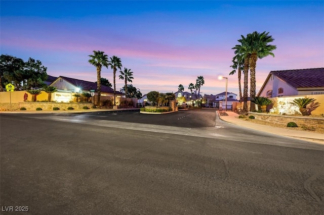 view of street with curbs, street lighting, sidewalks, and a residential view