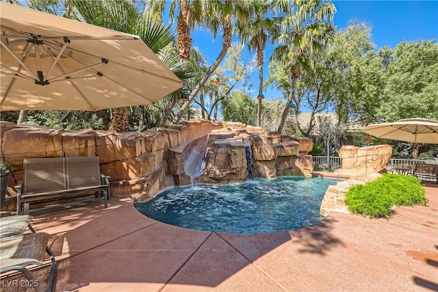 view of swimming pool featuring a patio area, fence, and a fenced in pool