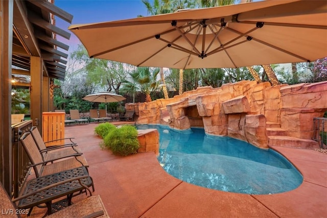 outdoor pool with a patio area and fence