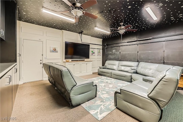 cinema with a ceiling fan and light colored carpet