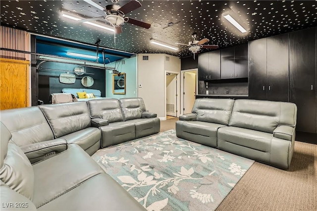 carpeted living area featuring a ceiling fan and visible vents