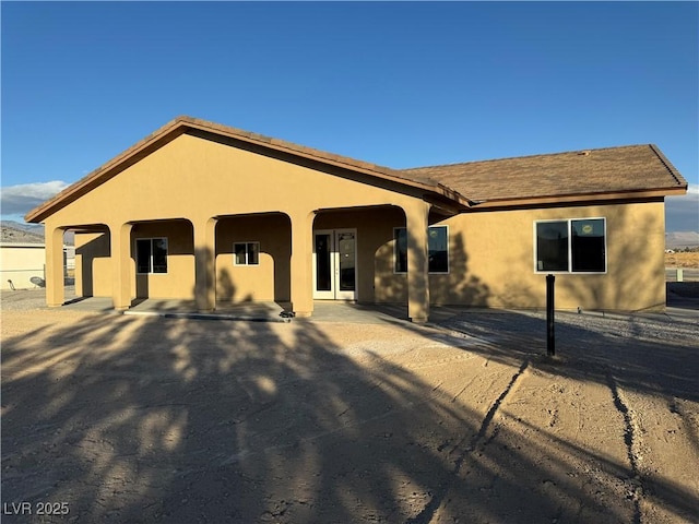 ranch-style home featuring stucco siding