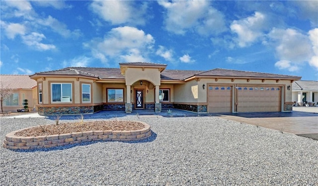 3080 S Prairie Ave, Pahrump, NV 89048 - mediterranean / spanish home with an attached garage, stucco siding, driveway, and stone siding