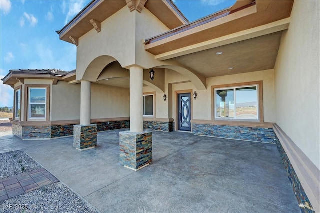 3080 S Prairie Ave, Pahrump, NV 89048 - entrance to property featuring stone siding, stucco siding, and a patio