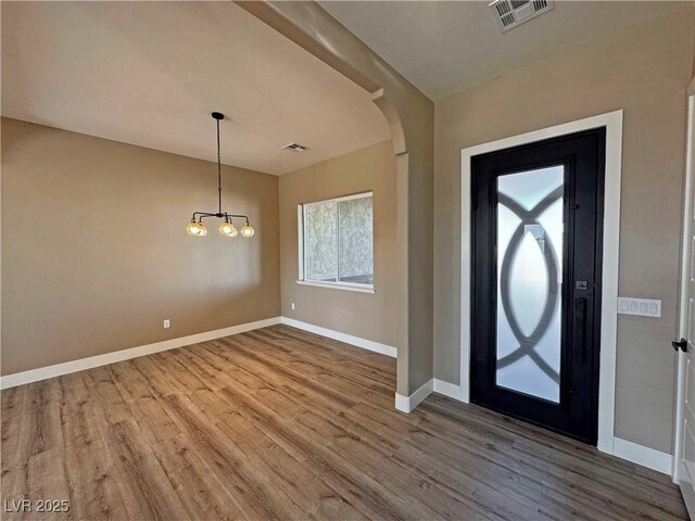 3080 S Prairie Ave, Pahrump, NV 89048 - entryway with baseboards, a notable chandelier, visible vents, and wood finished floors