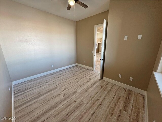 3080 S Prairie Ave, Pahrump, NV 89048 - unfurnished room with a ceiling fan, light wood-style floors, and baseboards