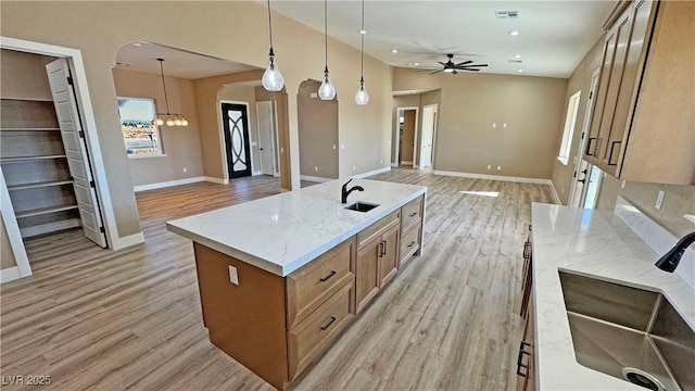 3080 S Prairie Ave, Pahrump, NV 89048 - kitchen featuring a sink, open floor plan, and light wood-style floors