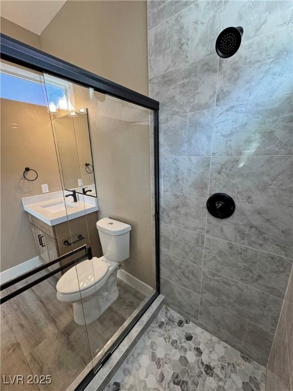 3080 S Prairie Ave, Pahrump, NV 89048 - bathroom featuring toilet, tiled shower, and vanity