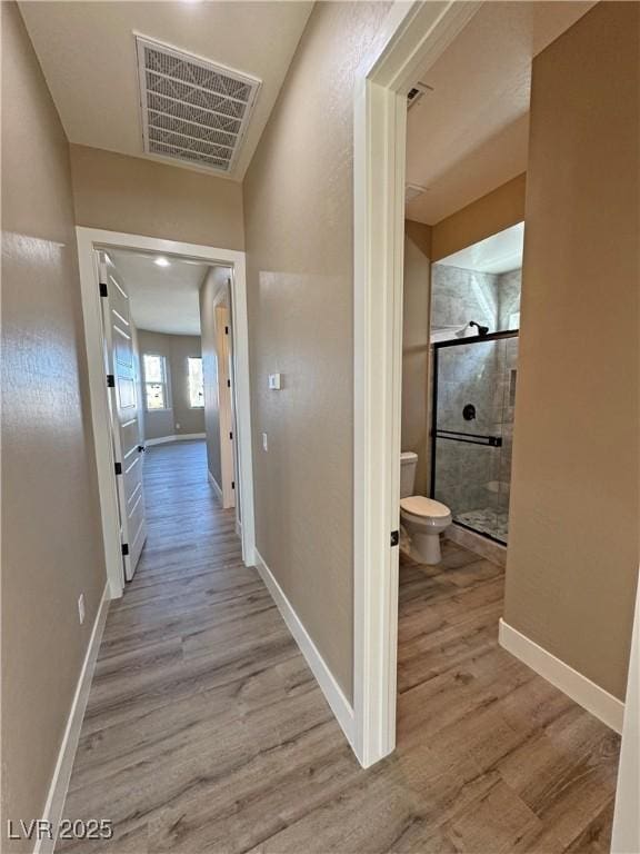 3080 S Prairie Ave, Pahrump, NV 89048 - hallway with baseboards, visible vents, and wood finished floors