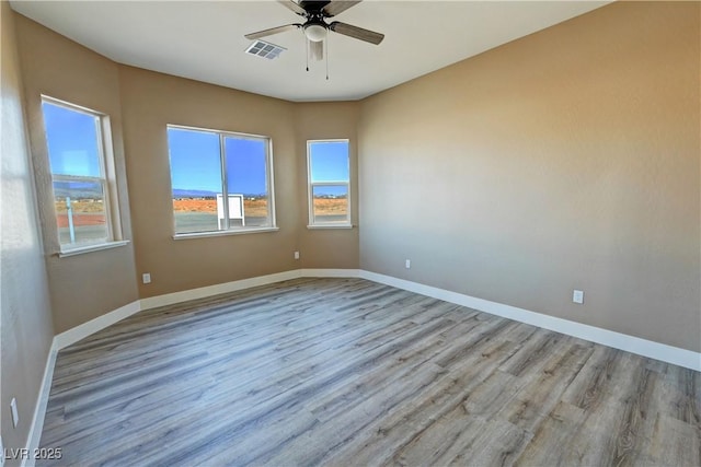 3080 S Prairie Ave, Pahrump, NV 89048 - spare room featuring wood finished floors, a ceiling fan, and baseboards