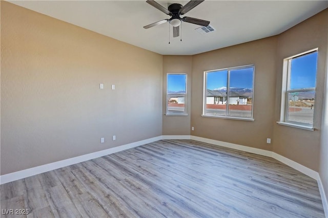 3080 S Prairie Ave, Pahrump, NV 89048 - empty room featuring visible vents, wood finished floors, baseboards, and ceiling fan