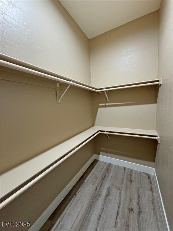3080 S Prairie Ave, Pahrump, NV 89048 - spacious closet with wood finished floors
