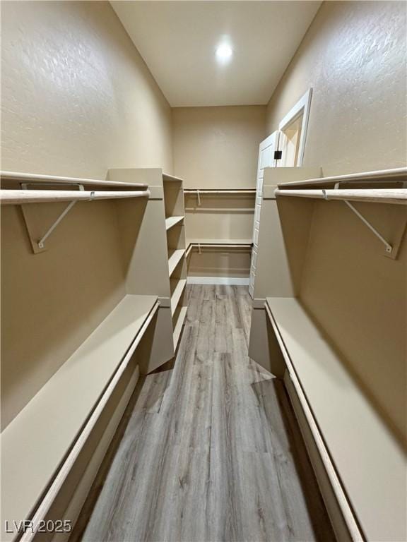 3080 S Prairie Ave, Pahrump, NV 89048 - walk in closet with light wood finished floors