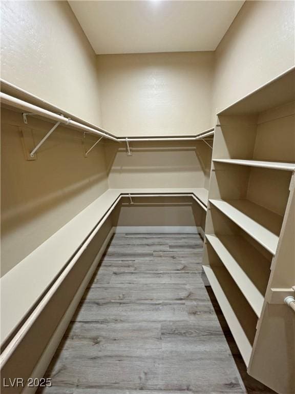 3080 S Prairie Ave, Pahrump, NV 89048 - spacious closet featuring wood finished floors