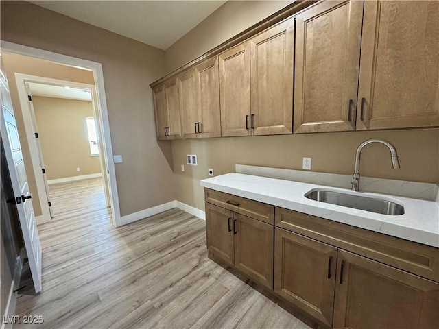 3080 S Prairie Ave, Pahrump, NV 89048 - washroom featuring electric dryer hookup, hookup for a washing machine, cabinet space, light wood finished floors, and baseboards