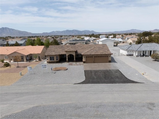 3080 S Prairie Ave, Pahrump, NV 89048 - ranch-style house featuring driveway, a garage, a mountain view, and a residential view