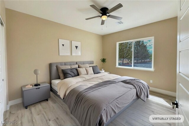 3080 S Prairie Ave, Pahrump, NV 89048 - bedroom featuring light wood-style floors, baseboards, and ceiling fan